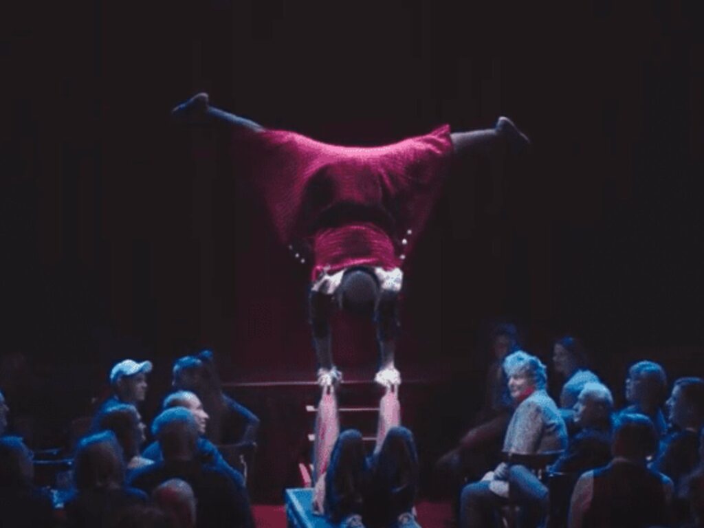 a person doing a handstand in front of a crowd