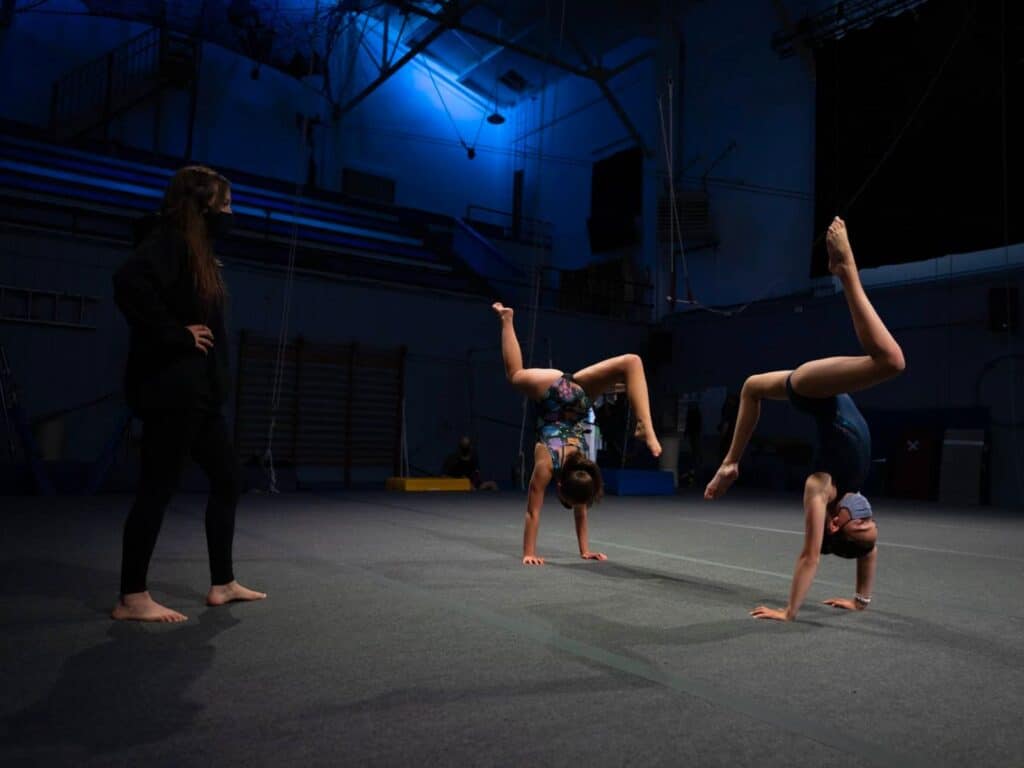 a group of gymnasts in an indoor gym