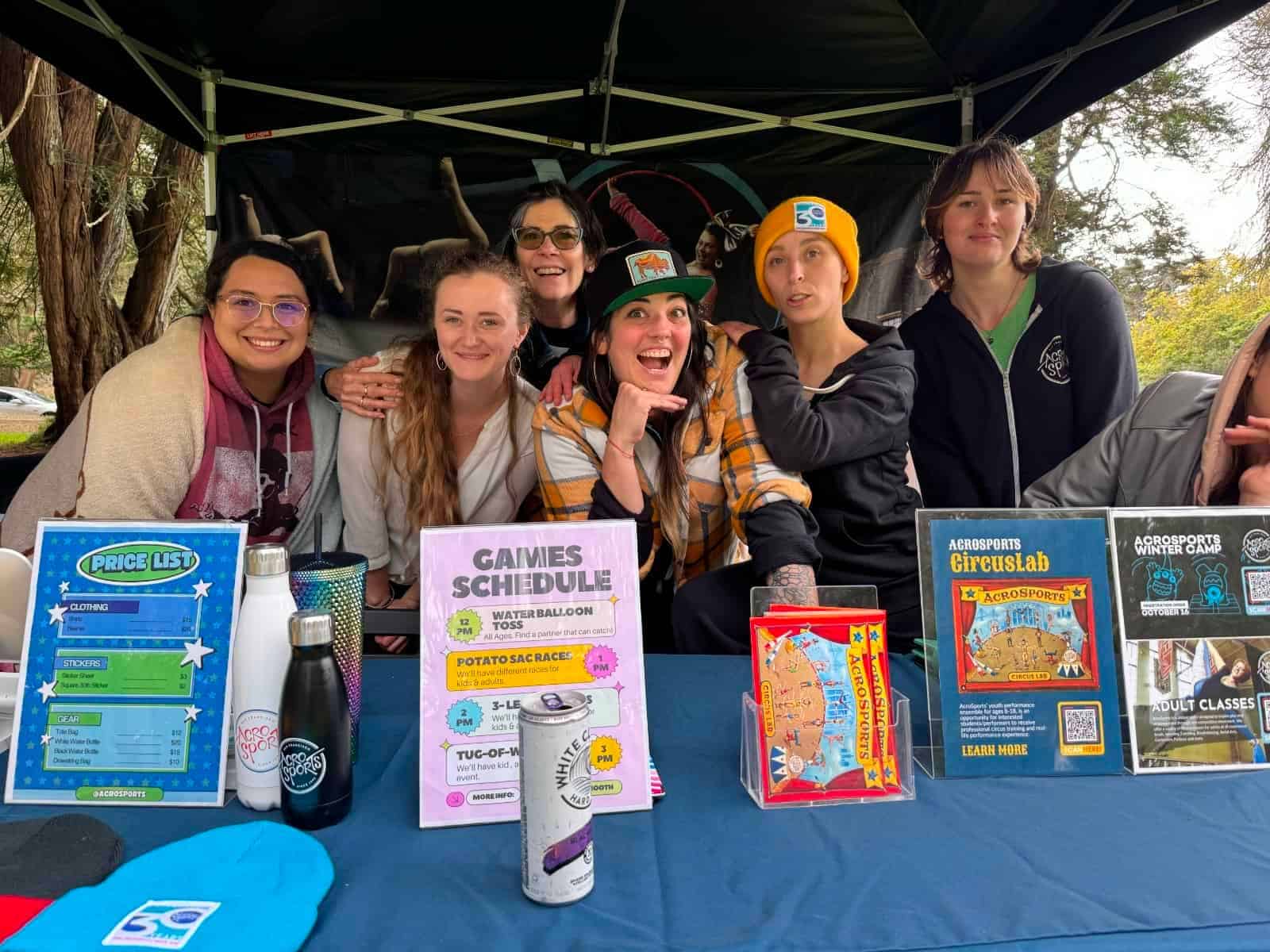 ACRO staffers posing for a photo under a tent